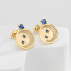 pair of gold plated celestial disc studs with blue accents