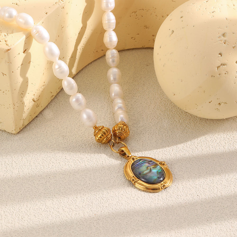 Blue-green iridescent center beneath textured gold tone beads