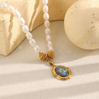 Blue-green iridescent center beneath textured gold tone beads