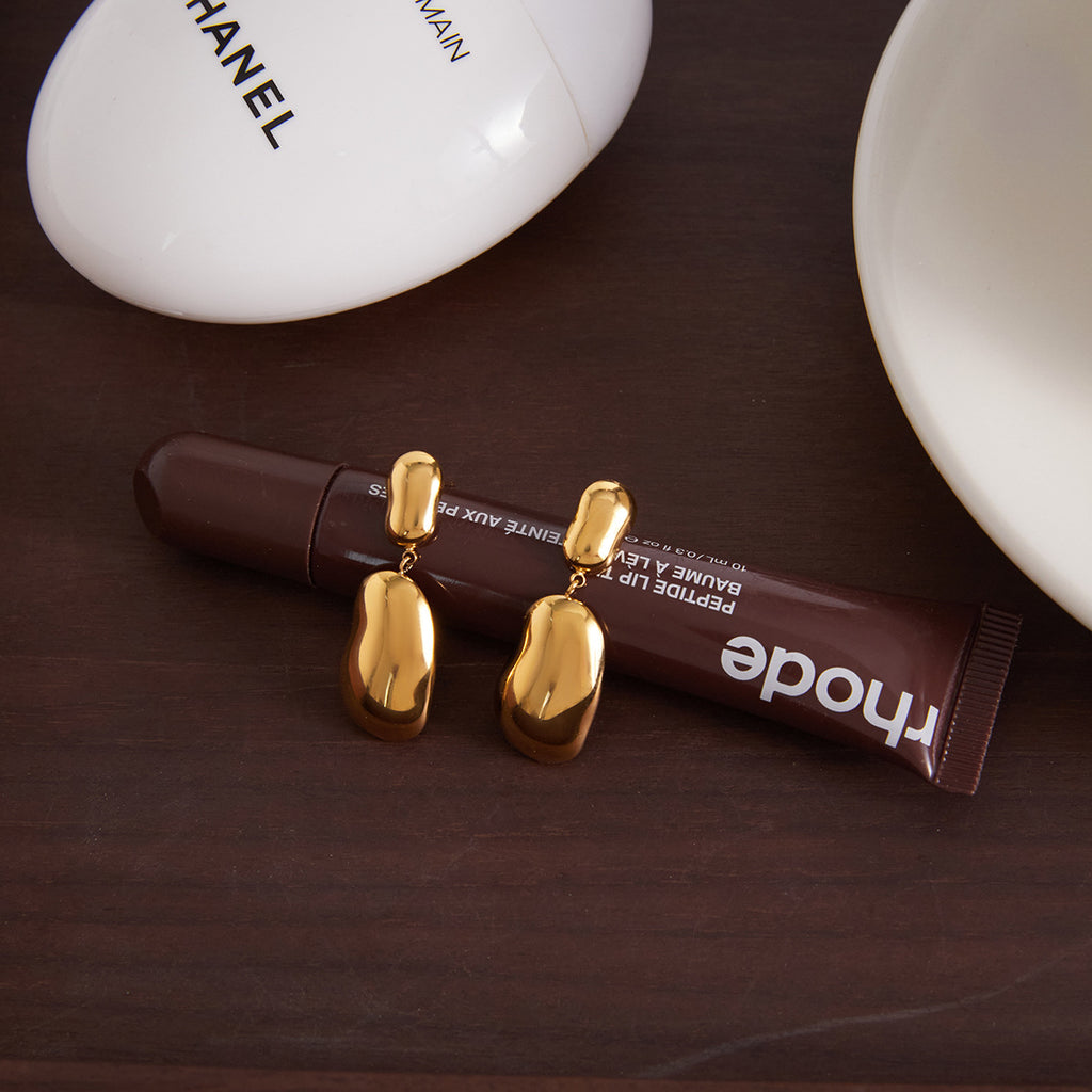 smooth irregular stainless steel pebble earrings in a styled setting