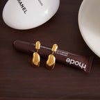 smooth irregular stainless steel pebble earrings in a styled setting