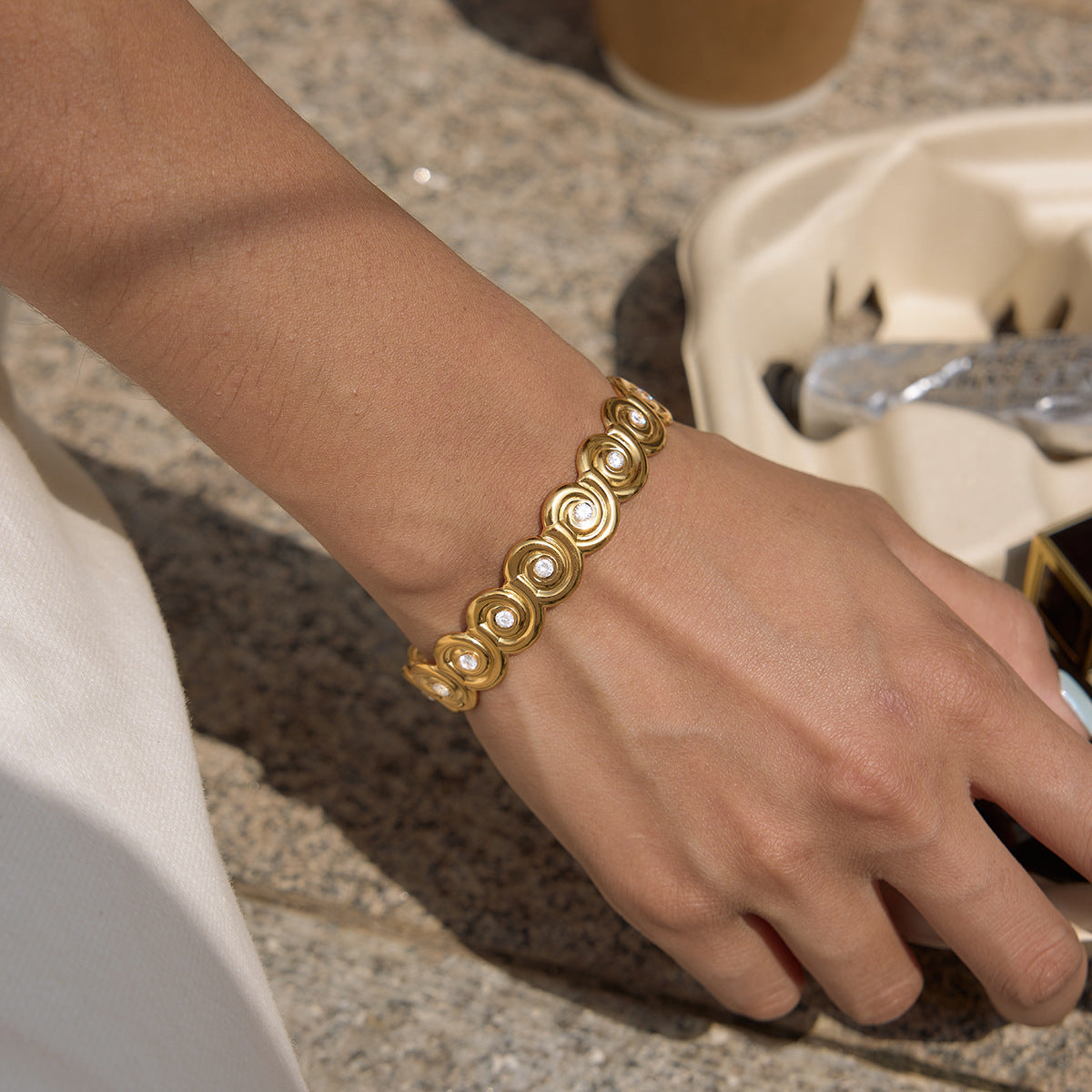 Narrow spiral cuff worn on a wrist