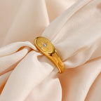 oval celestial signet ring styled on cream satin