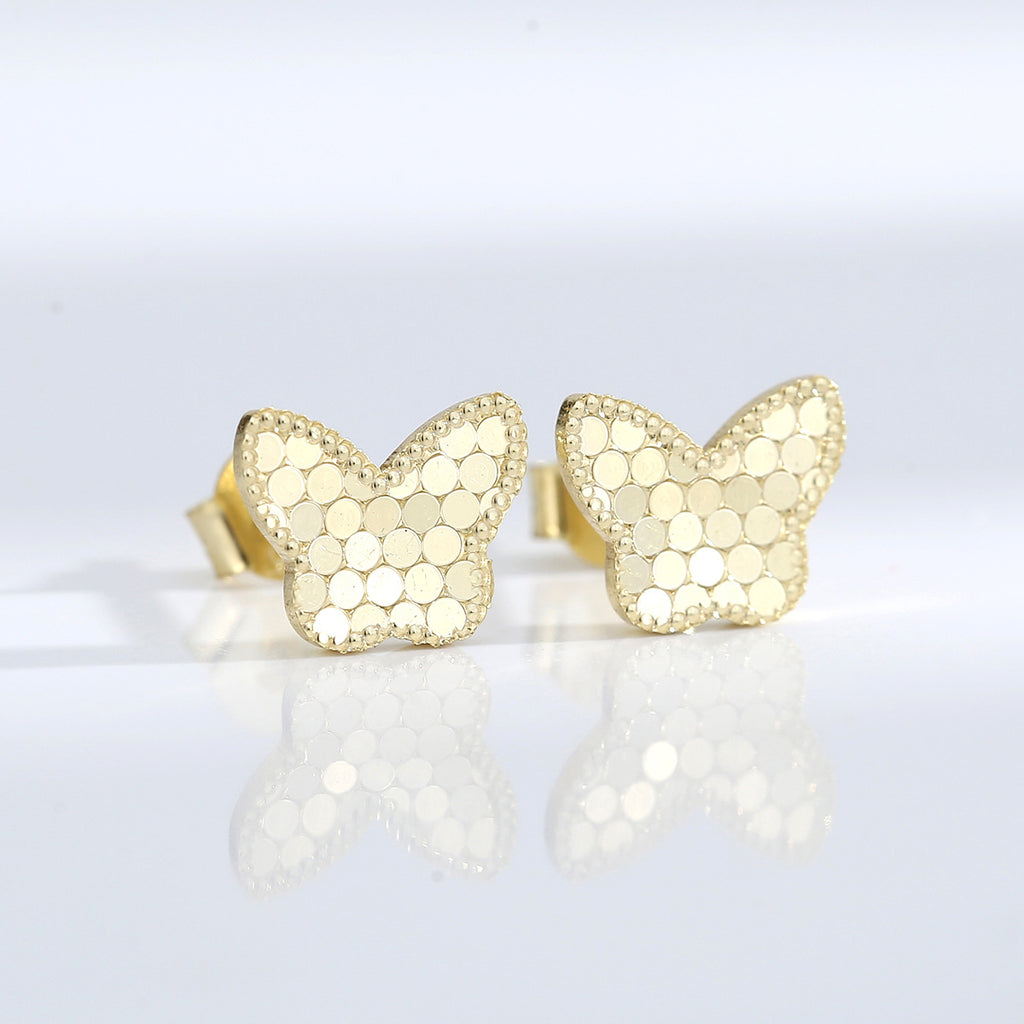 pair of gold plated butterfly studs with circular scale texture