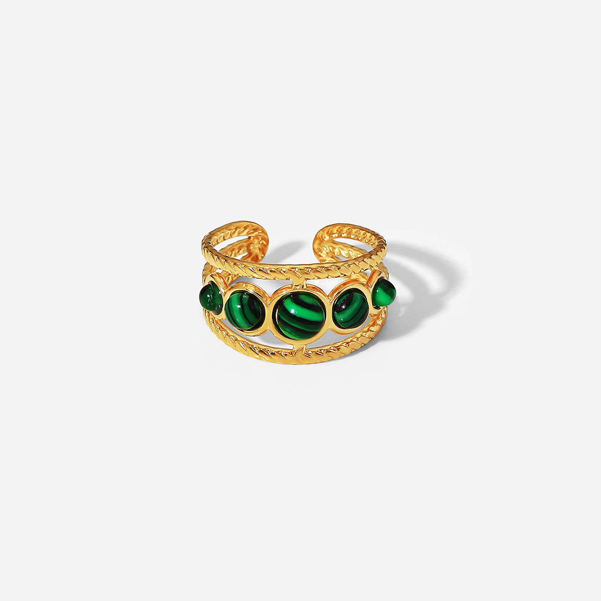 Front view of triple green stone open band ring