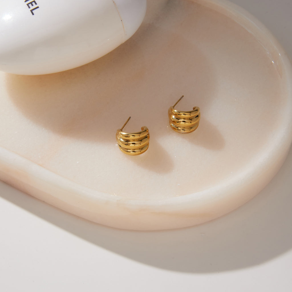 Triple ridge earrings showing posts on a white tray