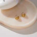 Triple ridge earrings showing posts on a white tray