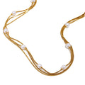 Gold plated triple-strand faux pearl necklace detail