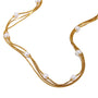 Gold plated triple-strand faux pearl necklace detail