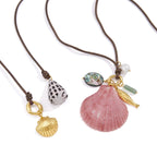Two cord necklace designs with shell details on white