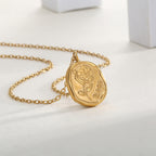 irregular rose medallion pendant displayed on a pale surface