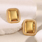 statement rectangular pearl-border earrings displayed on white blocks