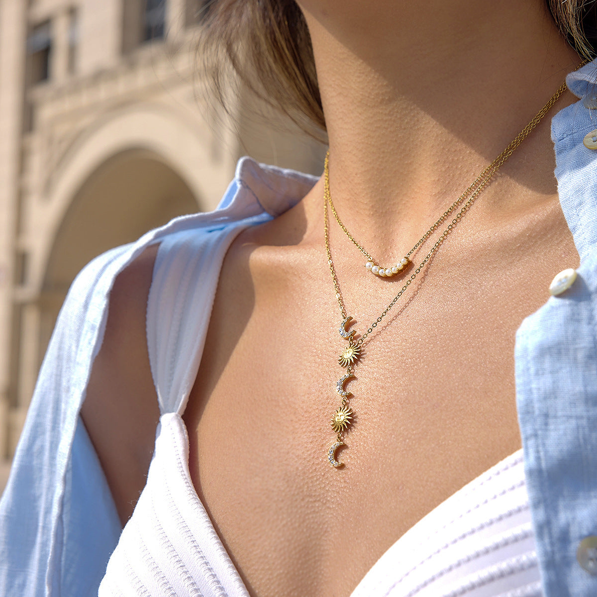 Sun and crescent moon Y necklace shown worn with another necklace