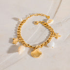 Scallop and turtle charms on the stainless steel curb bracelet