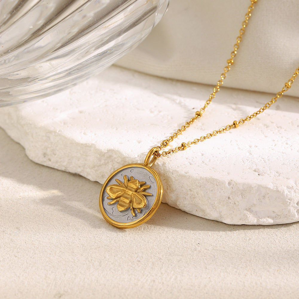 gold plated bee on a silver-finish round medallion necklace