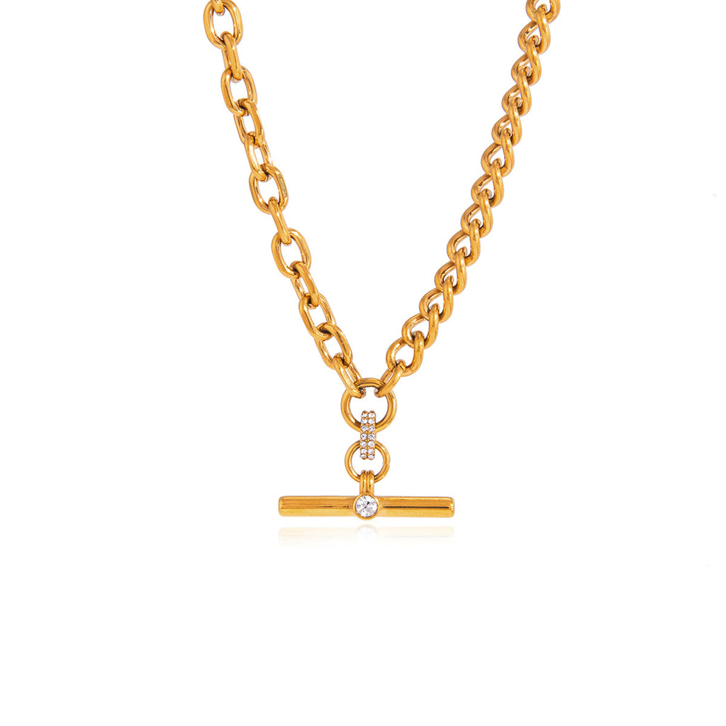 Gold-tone T-bar necklace laid on white