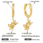 Polished crab charms hanging from hoop earrings