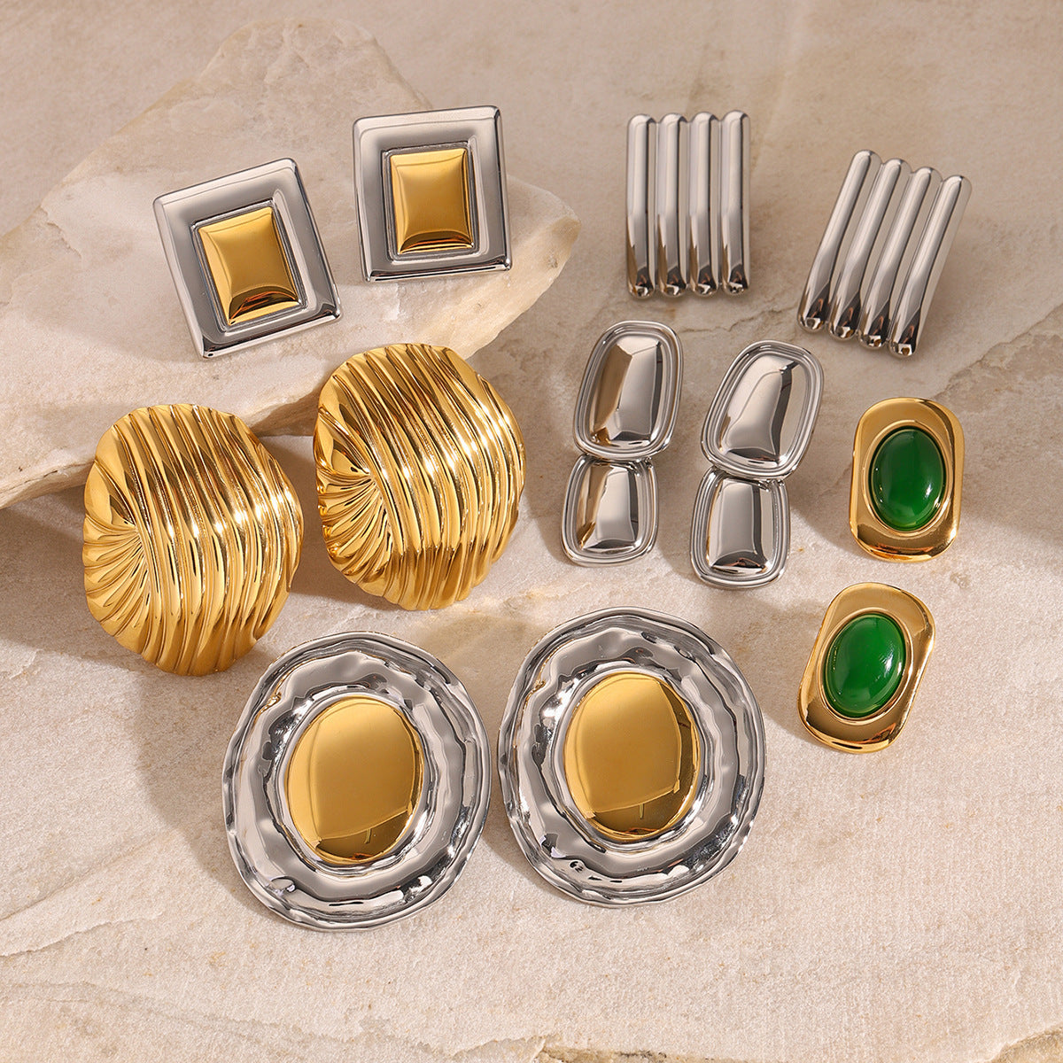 Large geometric studs and ribbed designs arranged on pale stone