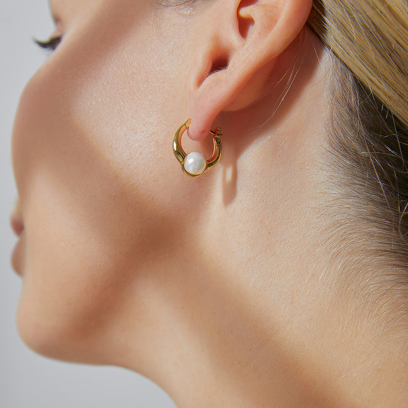 model wearing pearl huggie hoop earring