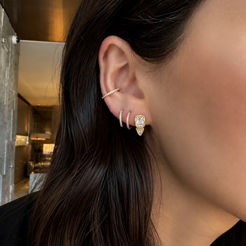 Rectangular and triangular stud worn with other ear jewelry