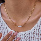 Model wearing fine gold-tone stainless steel necklace with small white accent