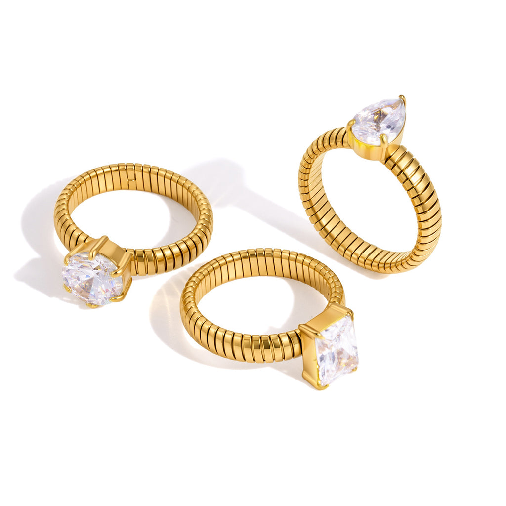Angled view of three gold-tone ribbed zirconia rings