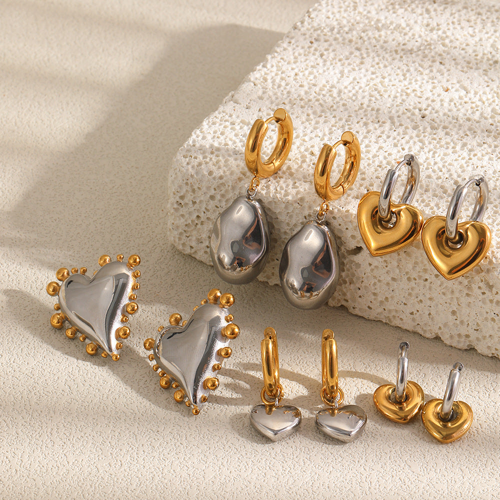 Two-tone heart and organic drop earring assortment on stone