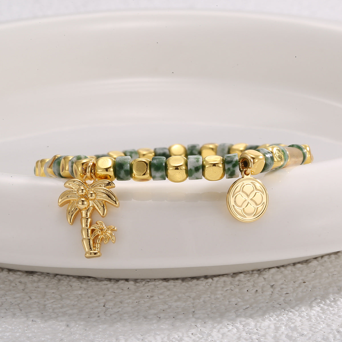 side close view of the beaded bracelet and two coastal charms