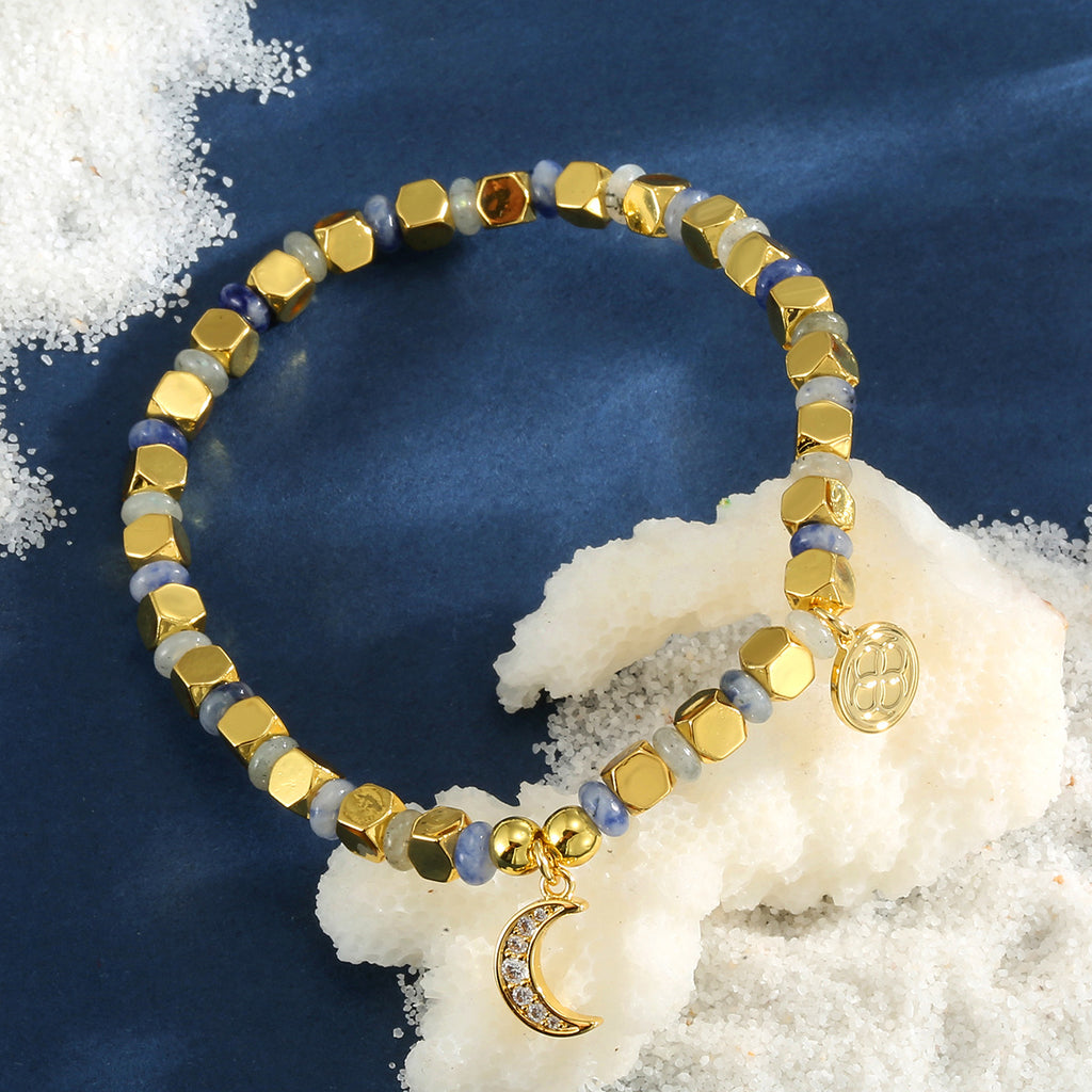blue dot quartz moon charm bracelet on a blue display