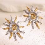 two-tone stainless steel spiral sunburst stud earrings on white stone