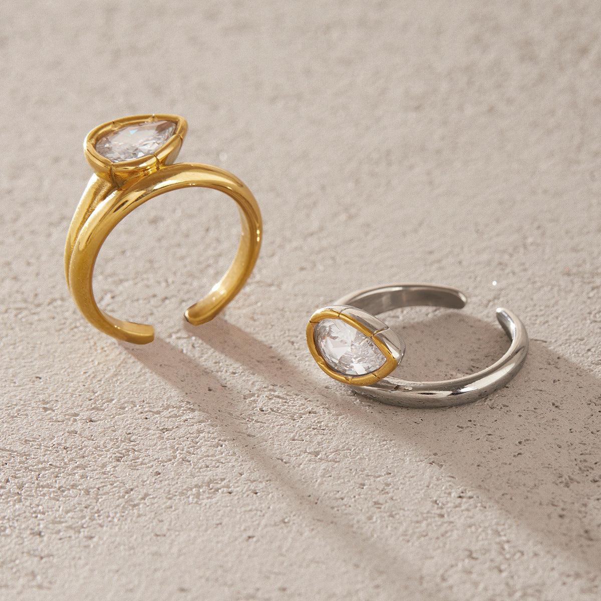 Gold tone and mixed-tone pear zirconia rings