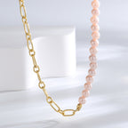 close view of the chain-to-bead transition on pink shell necklace