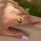 Round stone and polished teardrop ring shown on hand