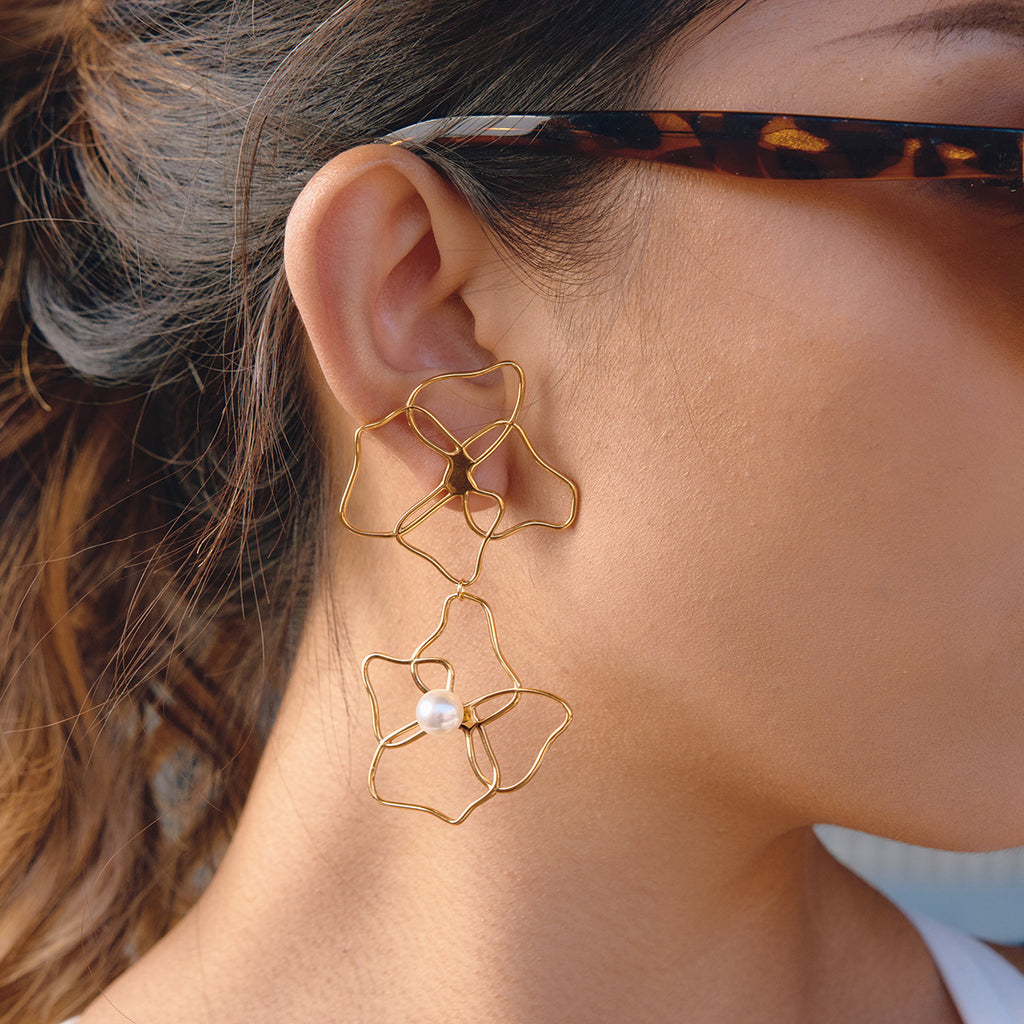 long stacked wire flower earrings shown in side view