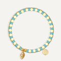 gold plated cowrie bracelet with turquoise-color cube beads