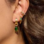 Green and clear accent stainless steel earring styles arranged together