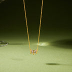 Gold-tone necklace with multicolor cube accents on green