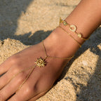 Spiral sun hand chain worn beside a celestial bracelet