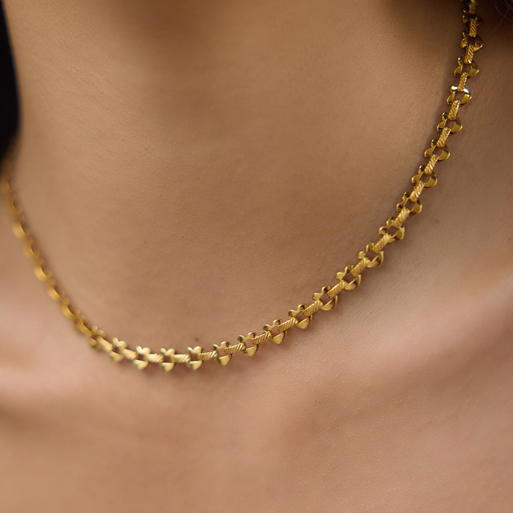 Textured heart-link stainless steel necklace at the neckline