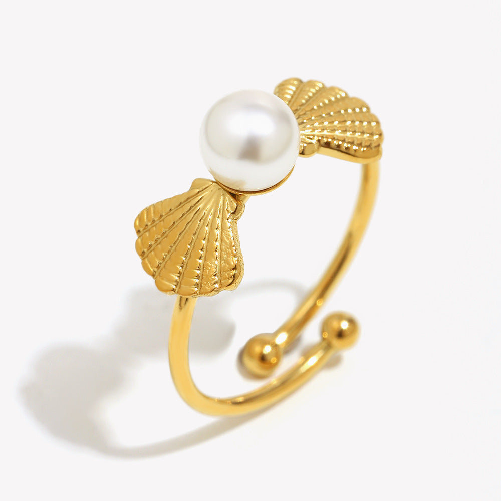 isolated gold plated stainless steel ring with shell and pearl details
