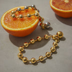 Close view of polished ball beads styled on orange slices