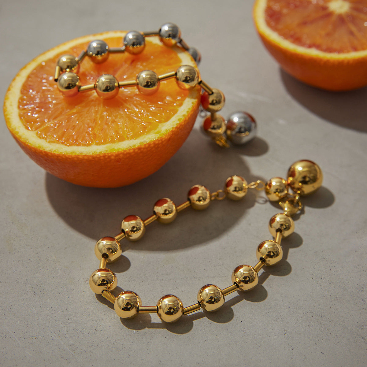 Close view of polished ball beads styled on orange slices