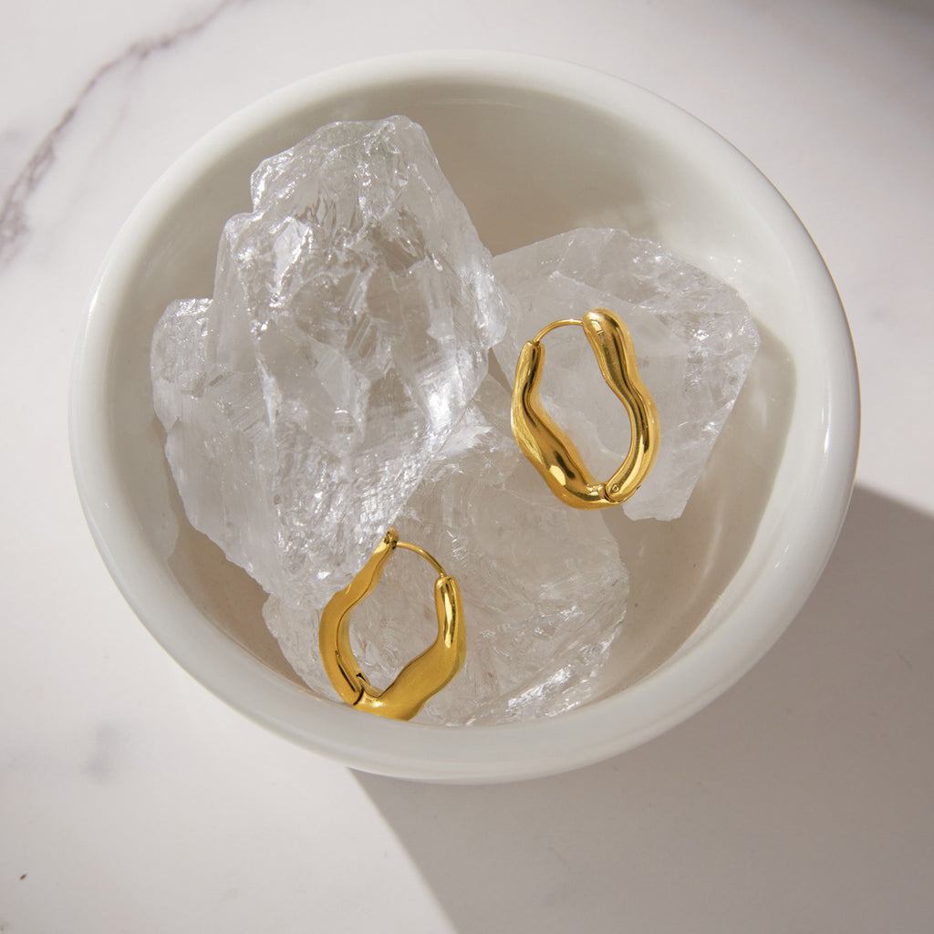 Pair of wavy hoops displayed on clear display stones