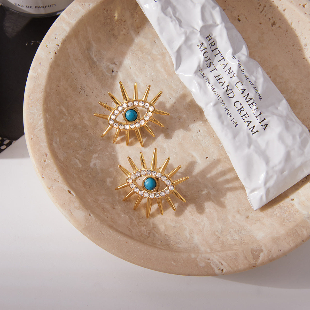 Blue Cabochon Evil Eye Stainless Steel Earrings and Ring — styled view of both designs