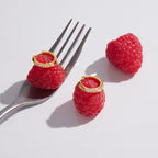 Gold finish stone-set hoops displayed on raspberries