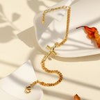 gold plated cross chain bracelet styled on a display stand