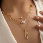 Cluster and bar-drop necklaces worn in layers