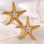 gold plated imitation pearl starfish stud earrings on white stone