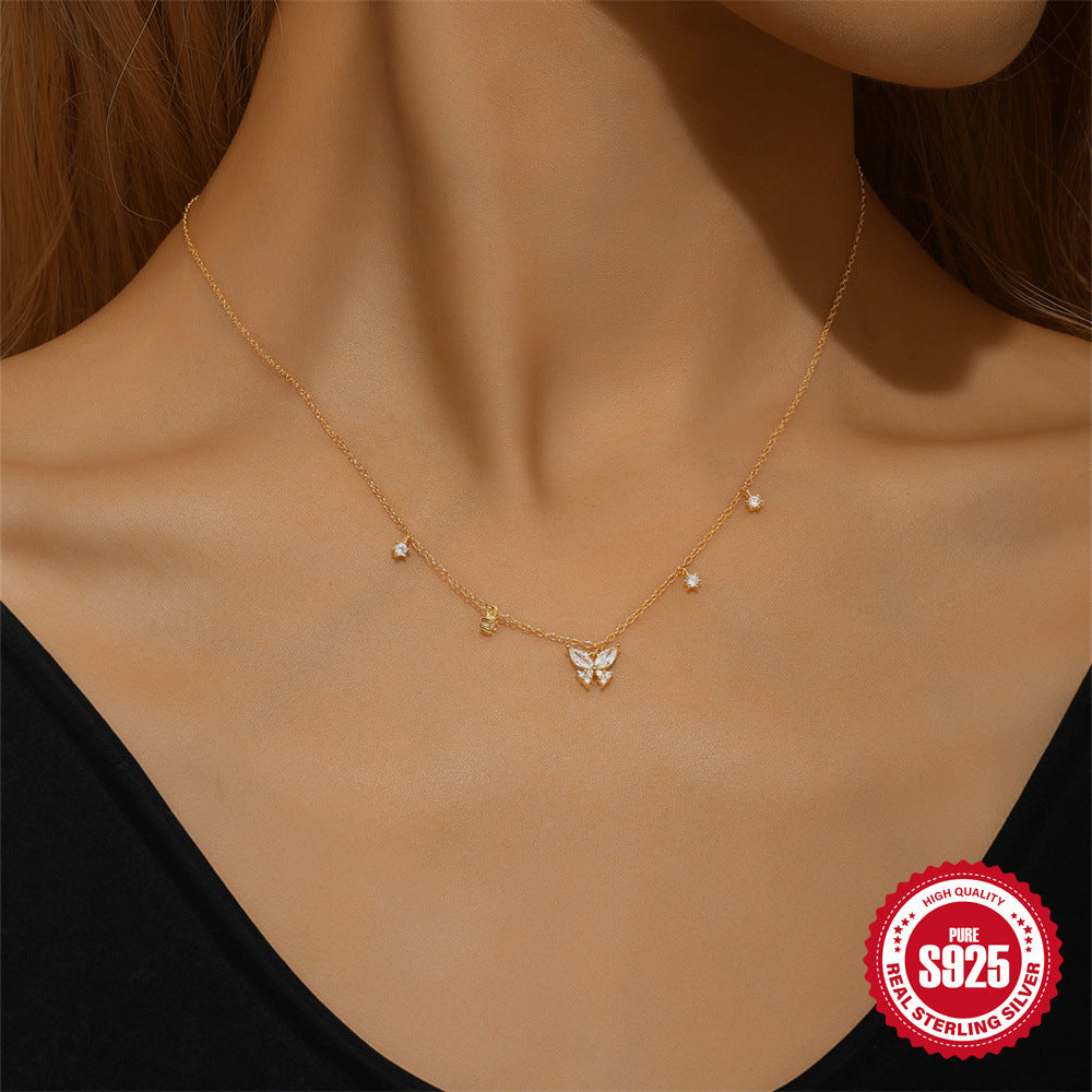model in black wearing the gold plated butterfly necklace