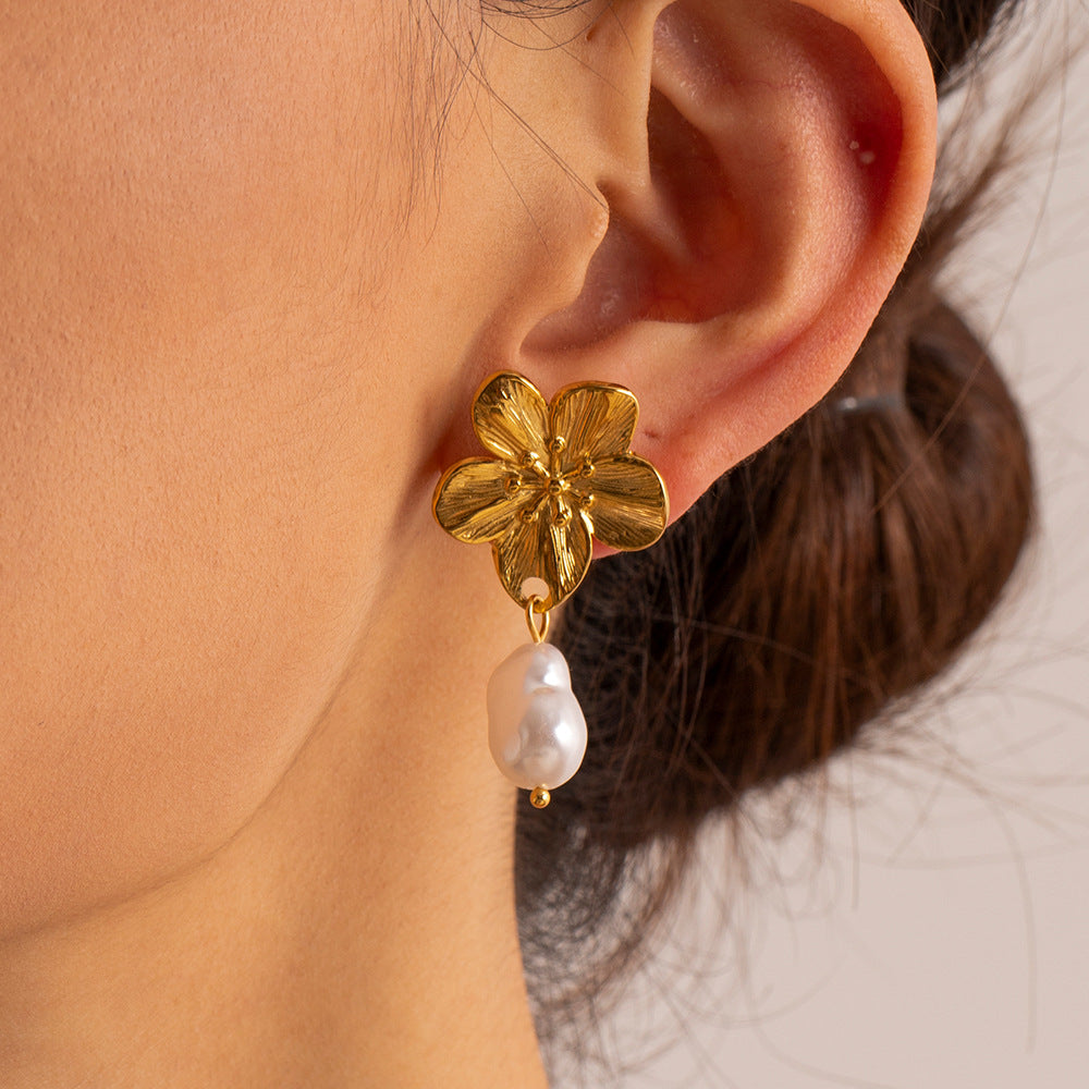 Sculptural flower drop earrings worn close-up